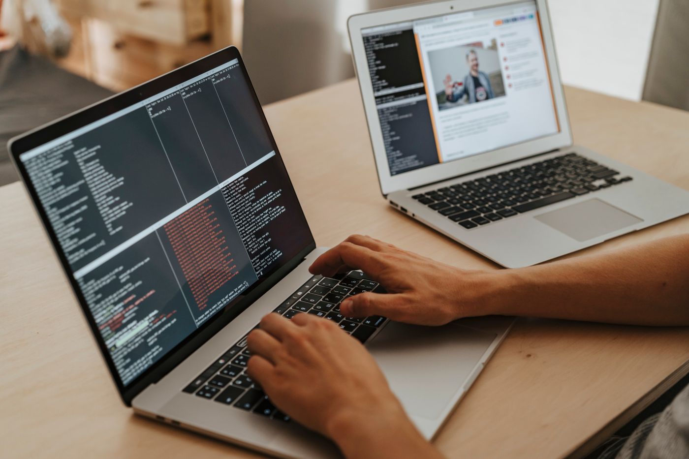 A developer writing code on a laptop
