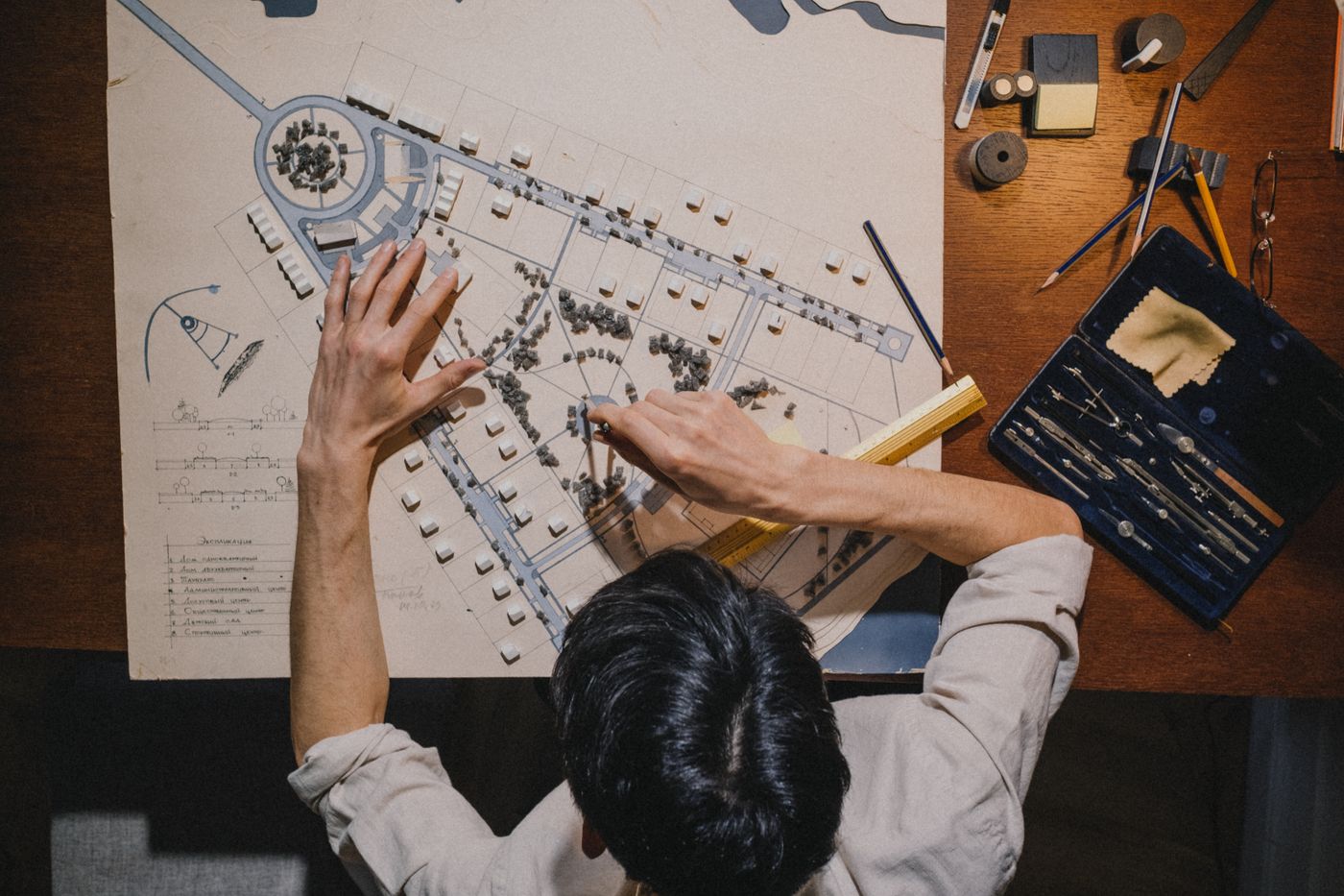 A planner working on a site plan of roads and buildings