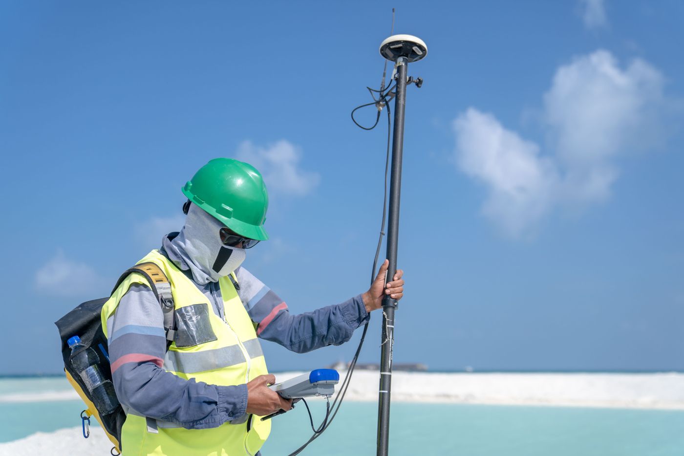 A surveyor taking a reading with a GNSS pole