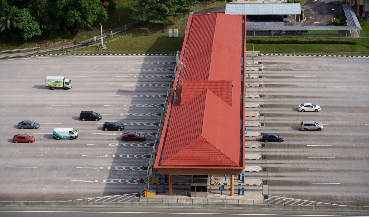 Cars passing through a toll plaza, seen from above